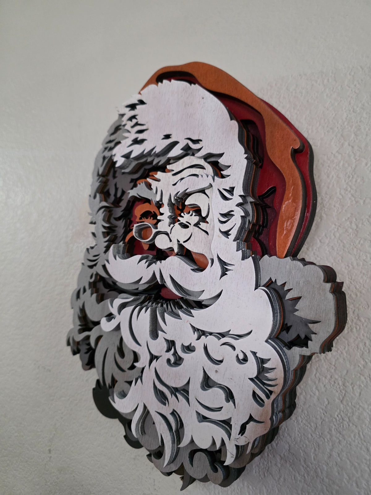 Side view of layered wooden Santa Claus Christmas wall art showing deep dimensional construction