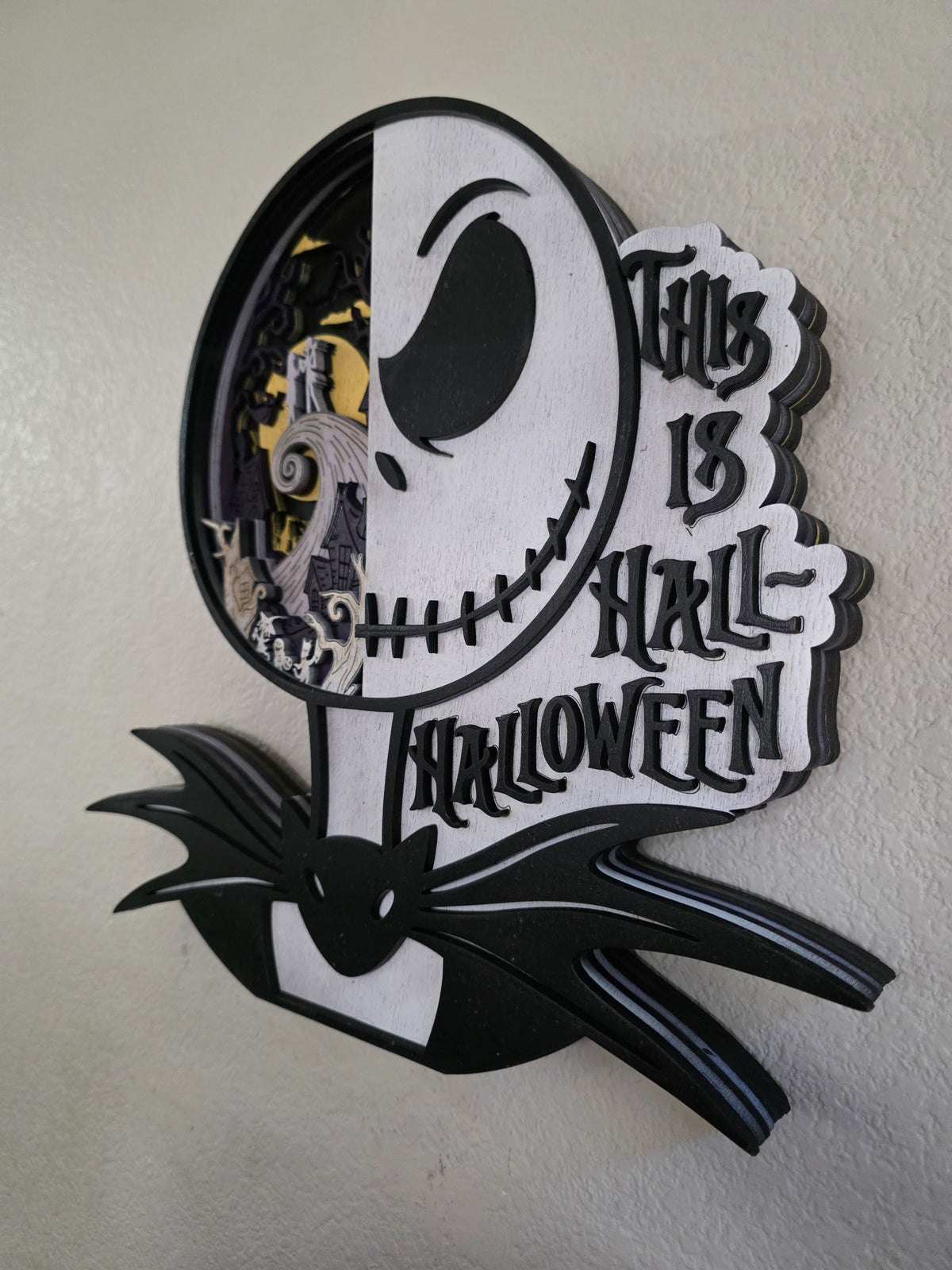Side view of layered wooden Halloween wall art showing deep dimensional construction and bold black and white silhouette