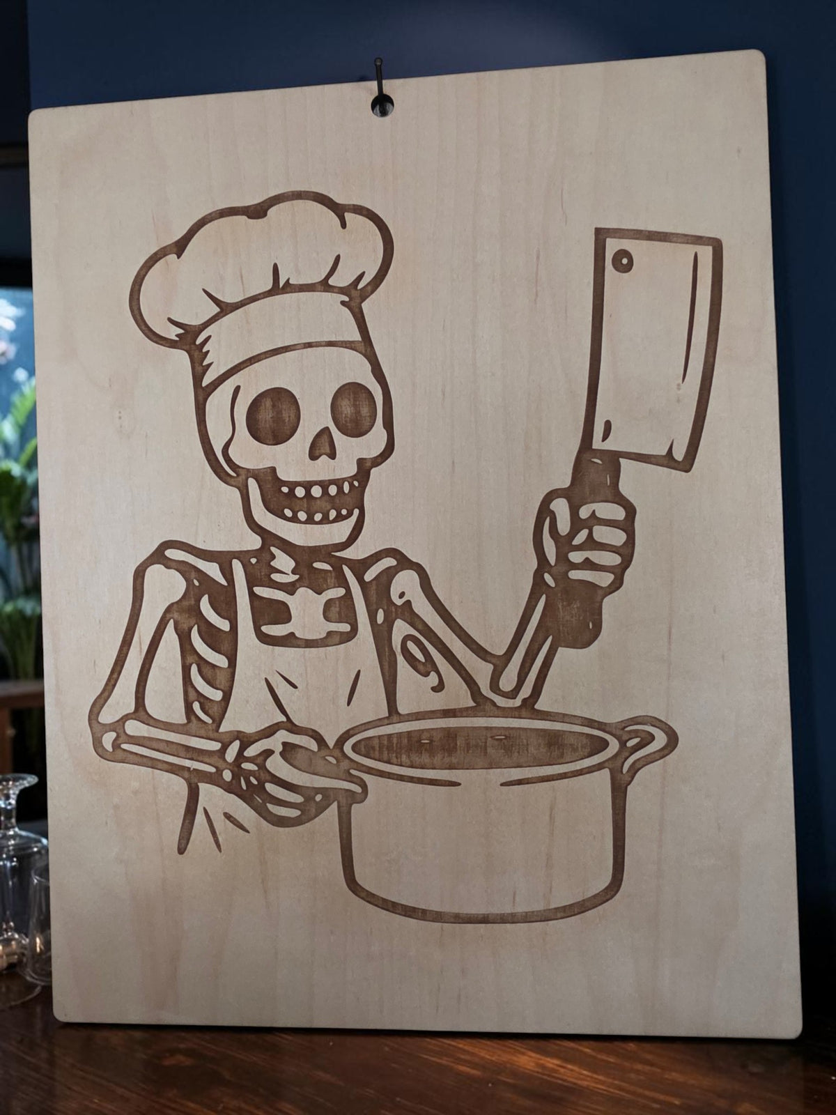 Skeleton Chef with Cleaver – 11" x 17" Engraved Maple Kitchen Wall Art