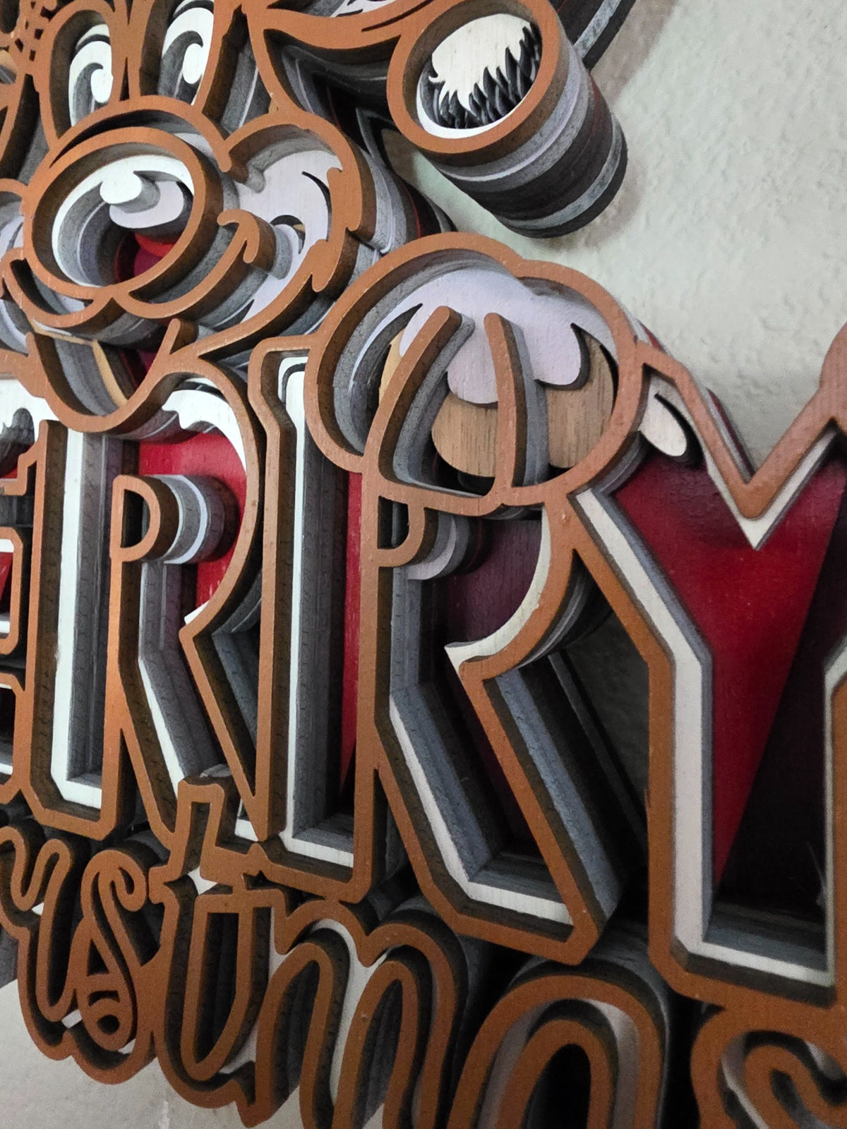 Close-up detail of Merry Christmas lettering and layered wood construction