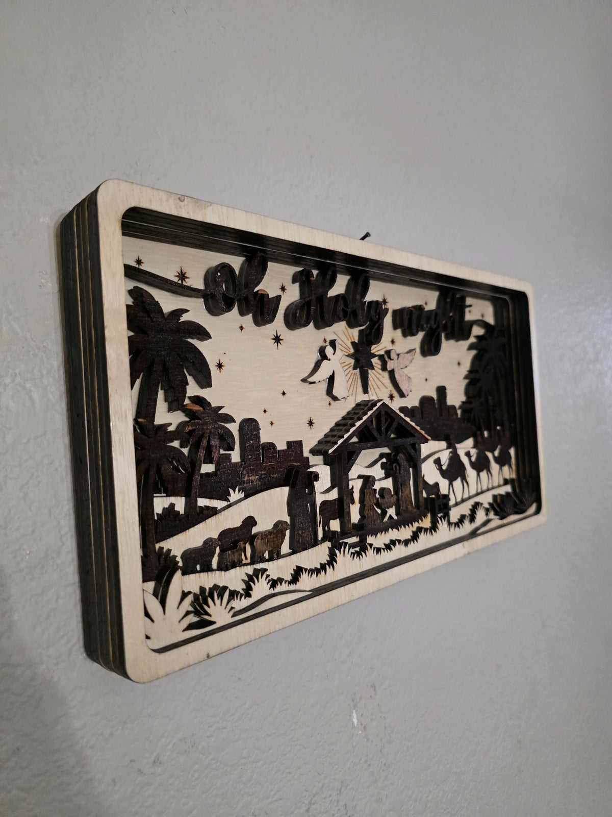 Left angle of O Holy Night layered wood nativity wall art showing depth